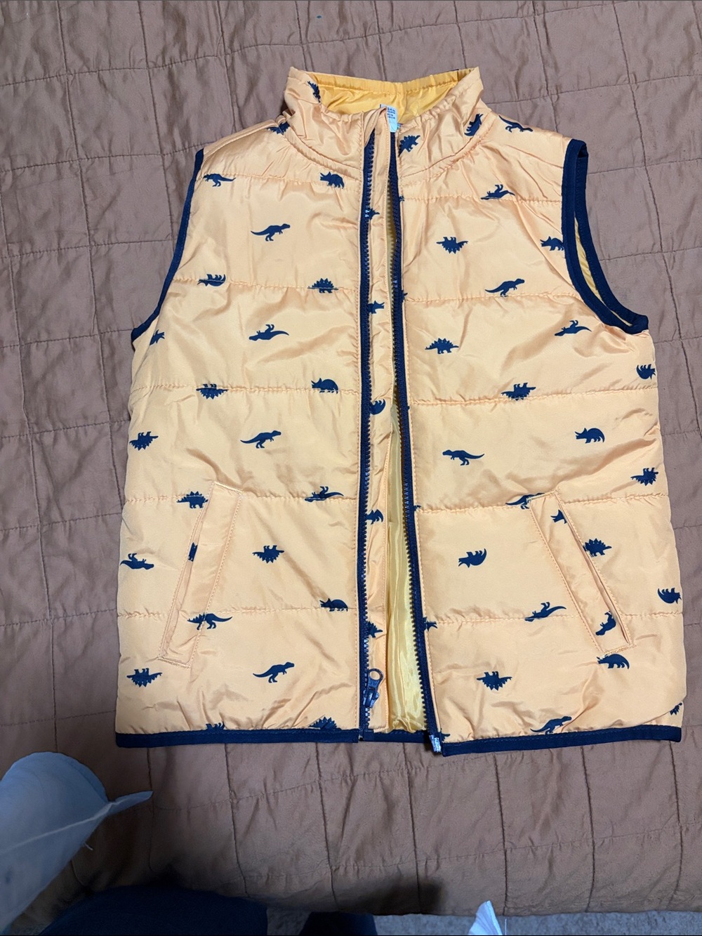 Yellow Puffer Vest with Navy Dinosaur Print - stegosaurus